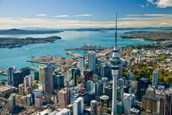 Aerial view of Auckland city featuring Sky Tower, Waitematā Harbour, and modern high-rise buildings, highlighting study abroad opportunities in New Zealand with ASK Consultants.