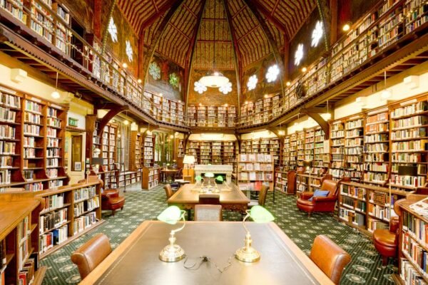 Ornate American library interior with vaulted wooden ceiling, bookshelves, and reading tables – study abroad guidance by ASK Consultants Karachi.
