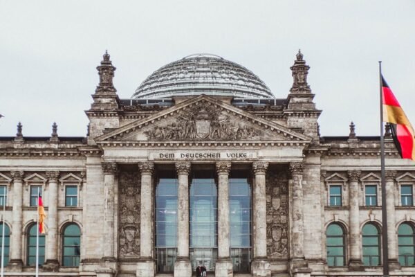 Reichstag building in Berlin, Germany with glass dome and German flags – study abroad guidance by ASK Consultants.