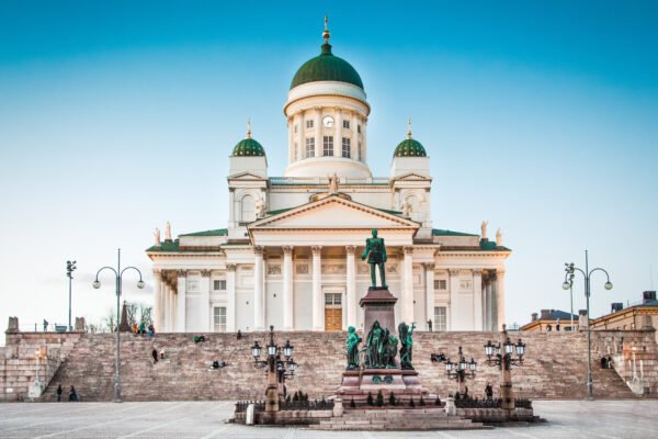 The white Neoclassical Helsinki Cathedral in Senate Square, Finland, with green domes and Alexander II statue, perfect for students planning Study Abroad with ASK Consultants.