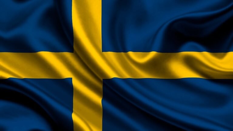 Close-up of the Swedish national flag in blue and yellow with realistic silk texture, highlighting study abroad opportunities with ASK Consultants.